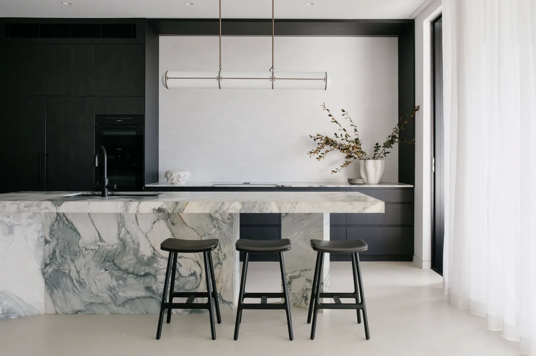 Freshwater &mdash; kitchen with dark oak cabinetry and a marble waterfall island, Northern Beaches