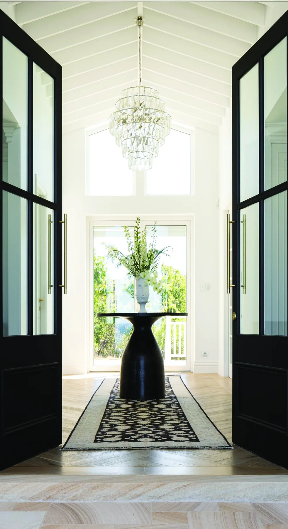 Elanora &mdash; black steel-framed double doors opening to the entry hall