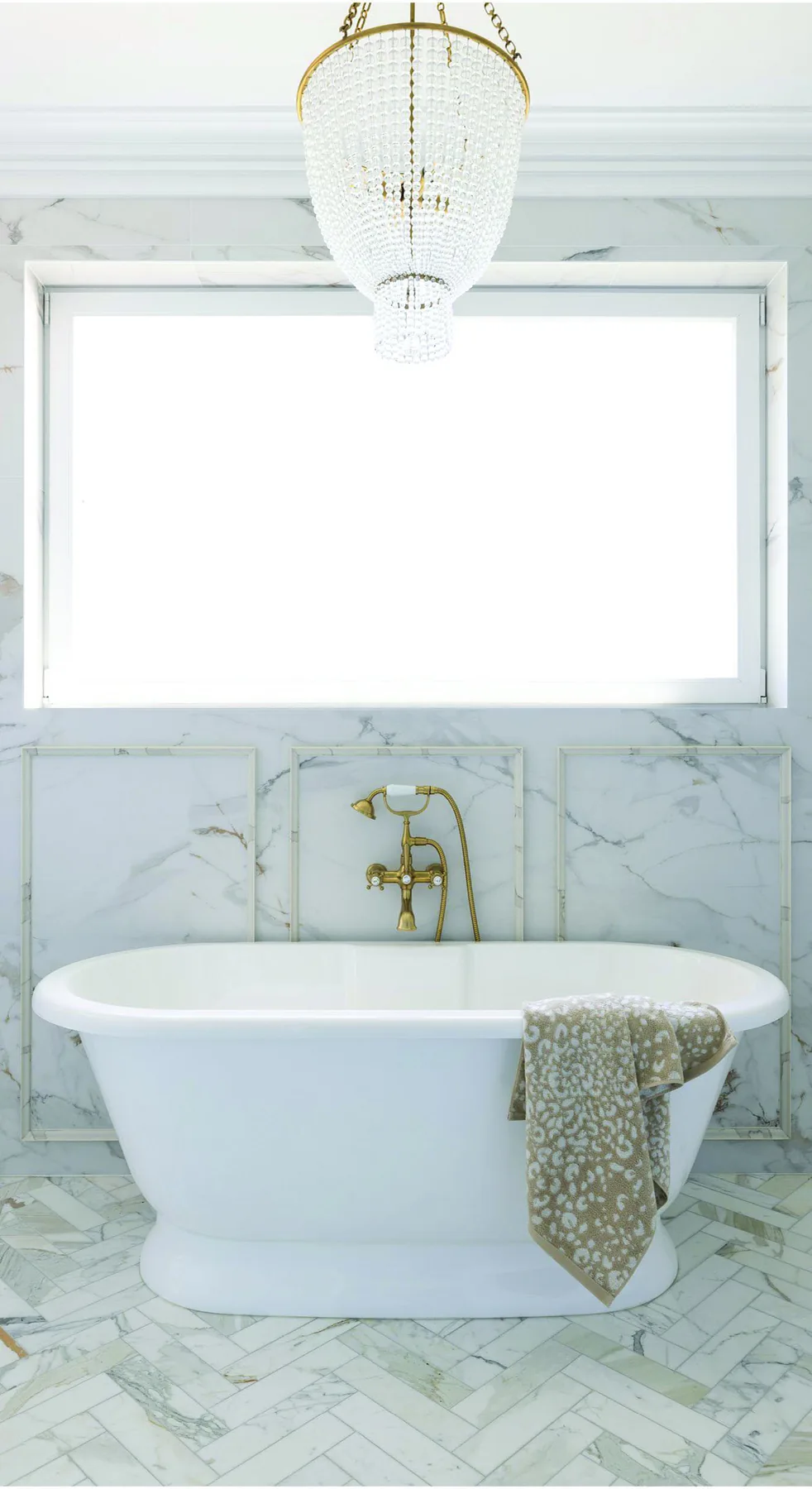 Elanora &mdash; main bathroom with freestanding bath, marble walls and herringbone floor