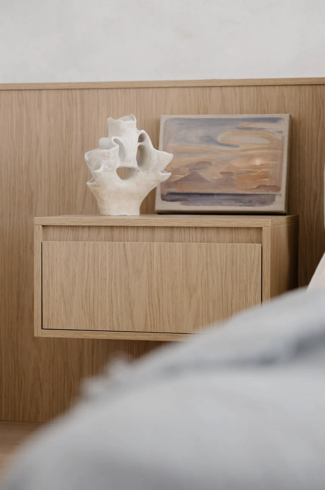 Freshwater — oak floating cabinet with ceramic sculpture and framed coastal artwork