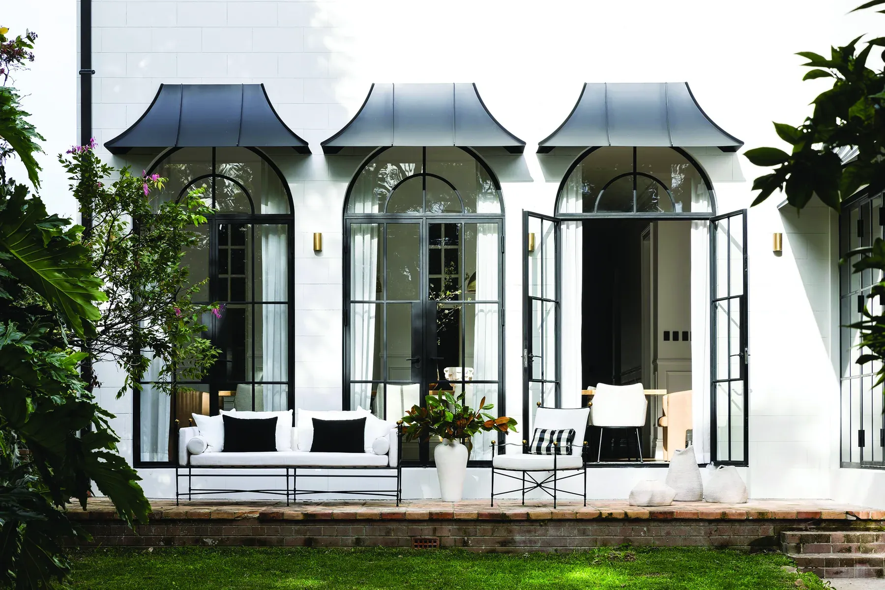 Mosman 01 &mdash; white terrace with arched steel-framed doors, metal awnings and outdoor lounge, Lower North Shore