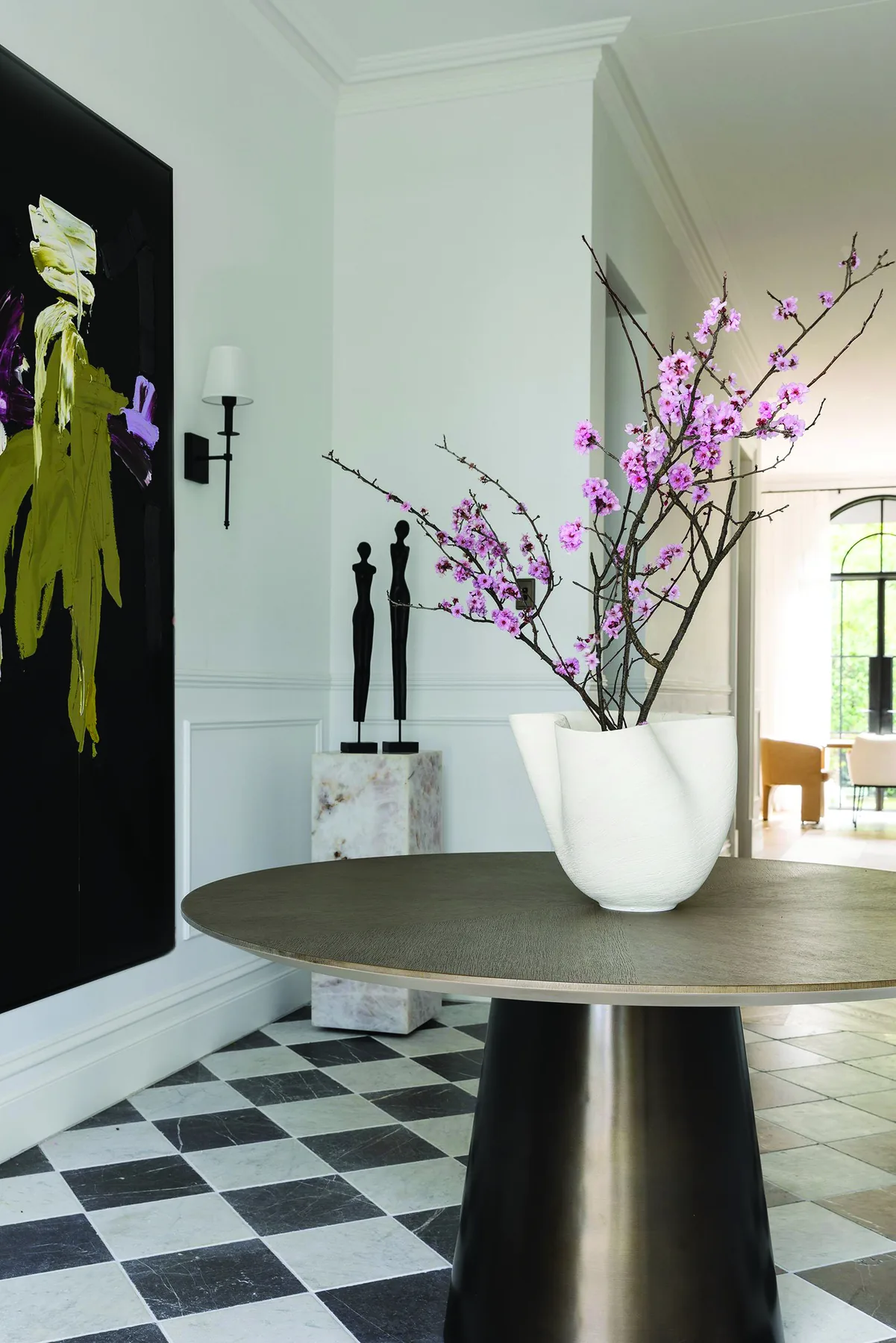 Mosman 01 — entry hall with round bronze table, chequerboard floor and abstract artwork
