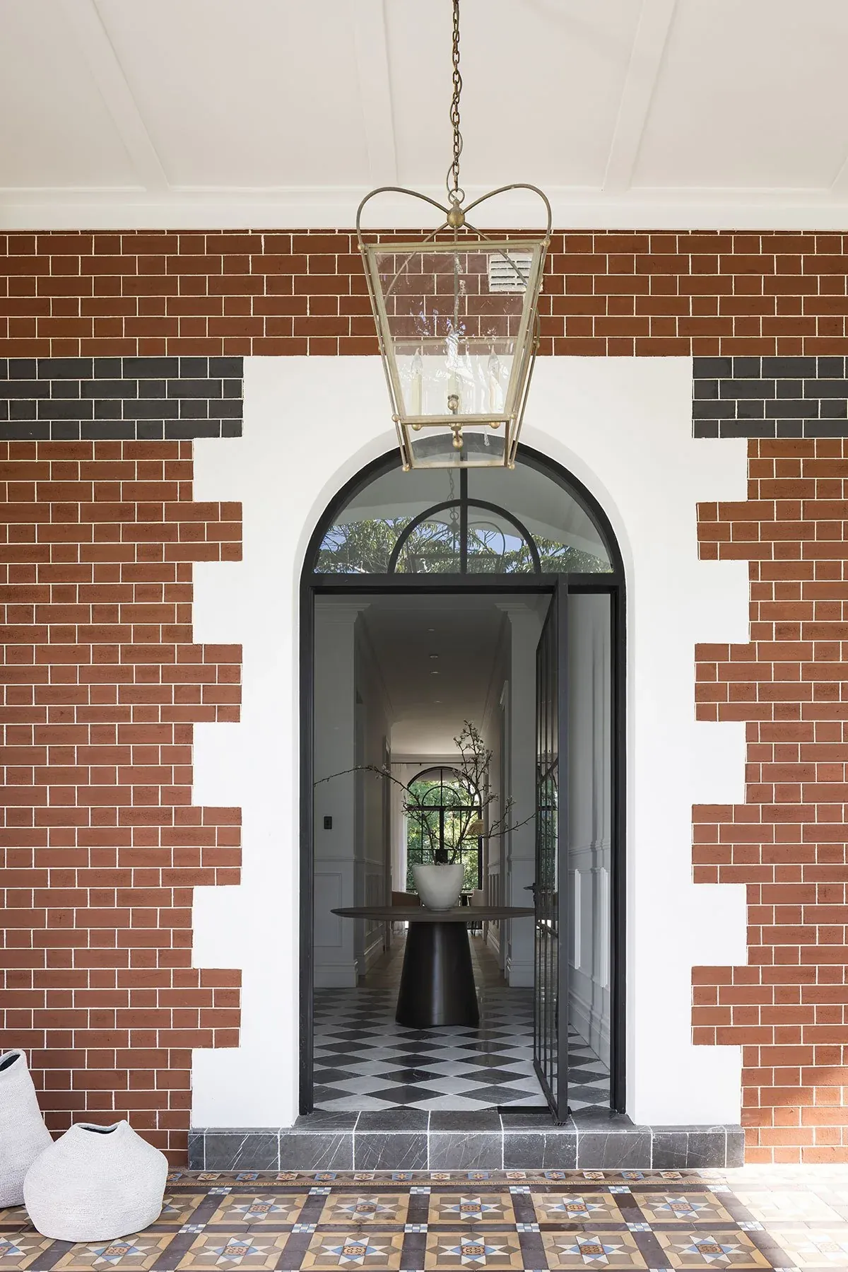 Mosman 01 &mdash; heritage red-brick entrance with white detailing, arched door and pendant lantern