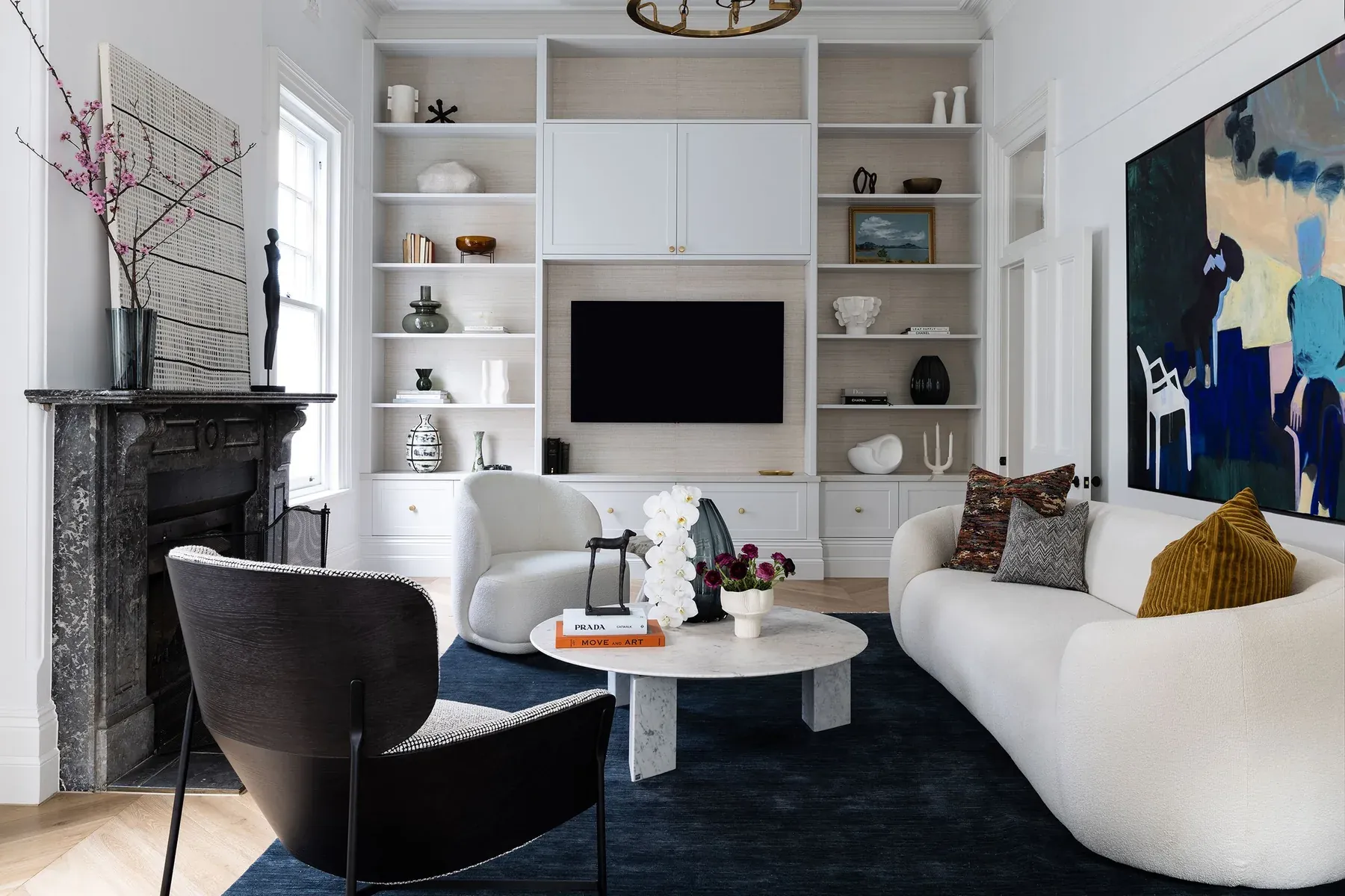 Mosman 01 &mdash; living room with curved white sofa, built-in shelving and large abstract painting