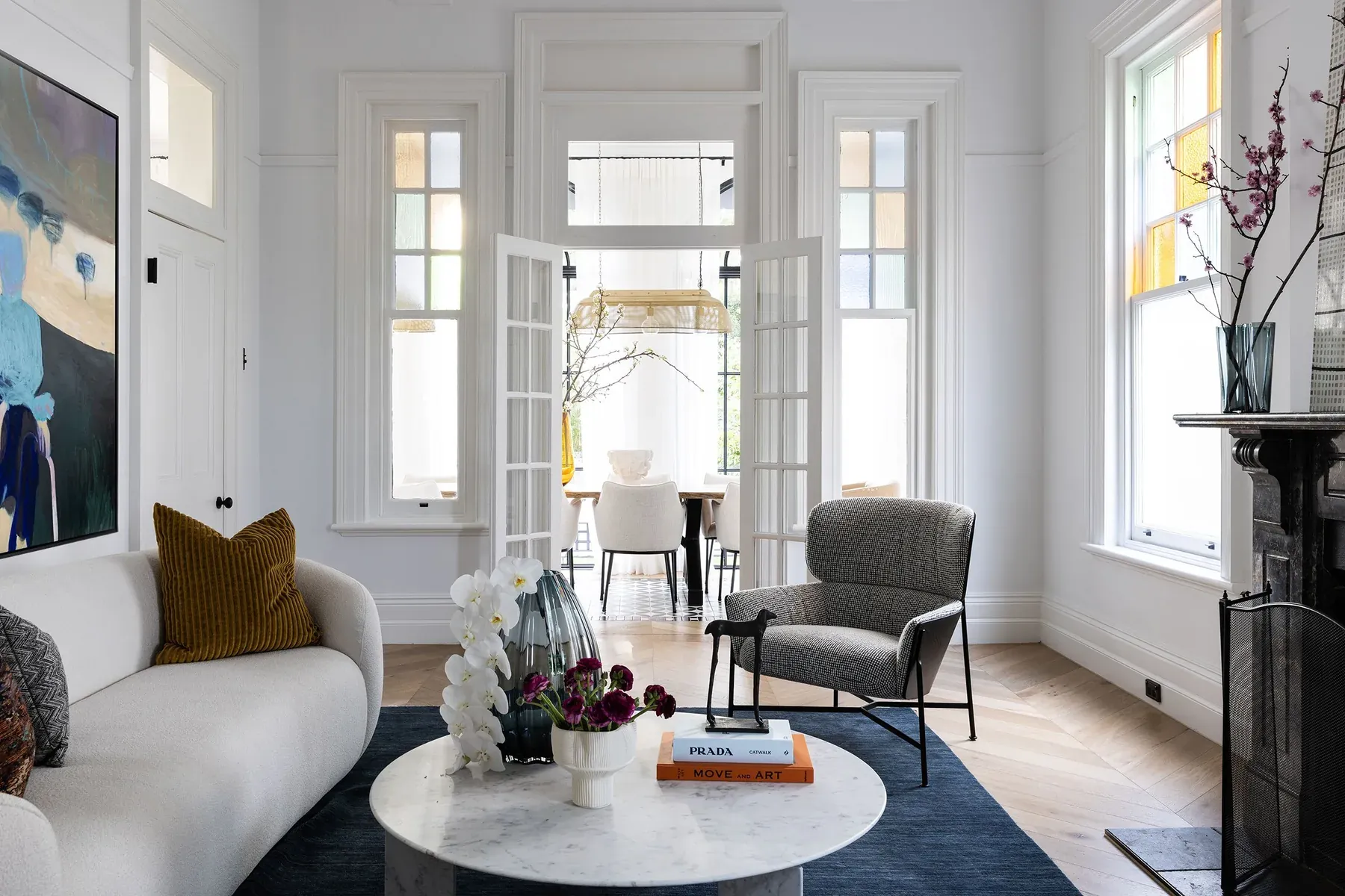 Mosman 01 &mdash; living room with white boucl&eacute; sofa and French doors through to the dining room
