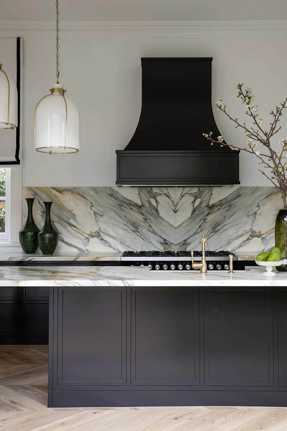 Mosman 01 &mdash; kitchen island in dark joinery with marble benchtop and glass pendant