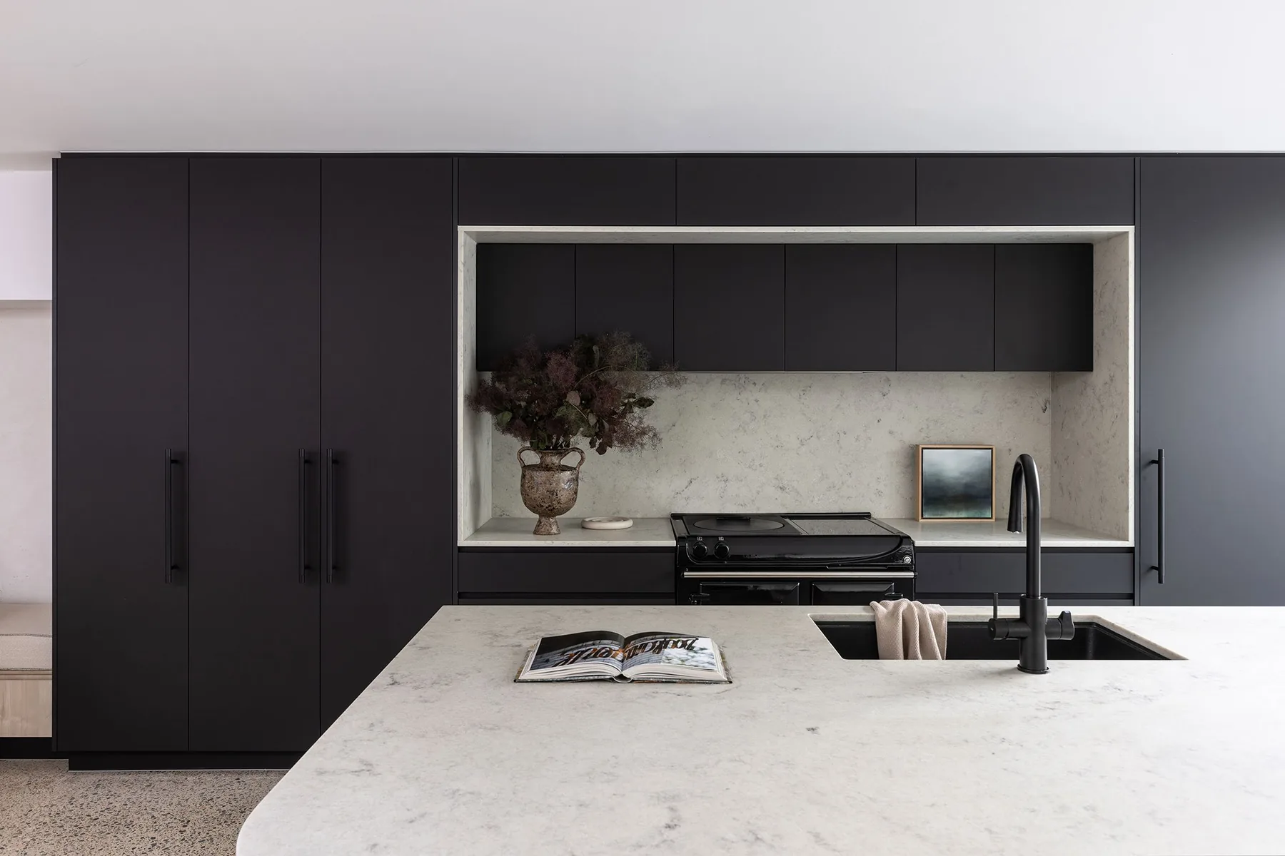 North Sydney &mdash; black kitchen cabinetry with stone benchtop and recessed splashback