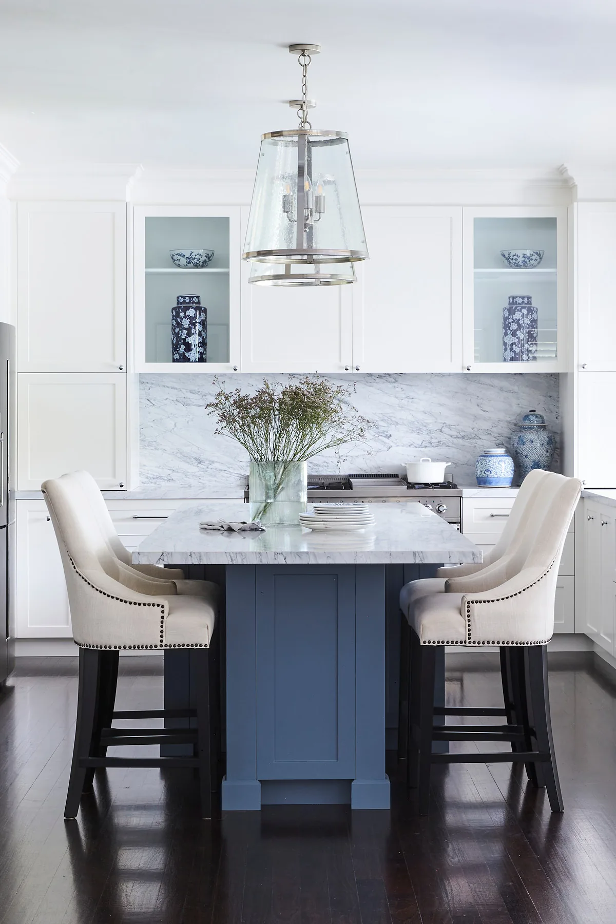 Wahroonga &mdash; kitchen island with cream stools beneath a glass lantern pendant